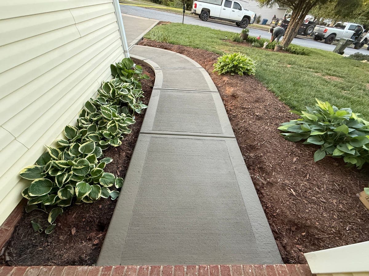 Finished Concrete Sidewalks job in Burlington, North Carolina by Local Concrete Contractor — clean control-joint pattern, smooth troweled surface, full property protection during pour.