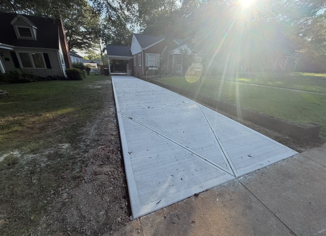 Finished Concrete Driveways job in High Point, North Carolina by Local Concrete Contractor — clean control-joint pattern, smooth troweled surface, full property protection during pour.