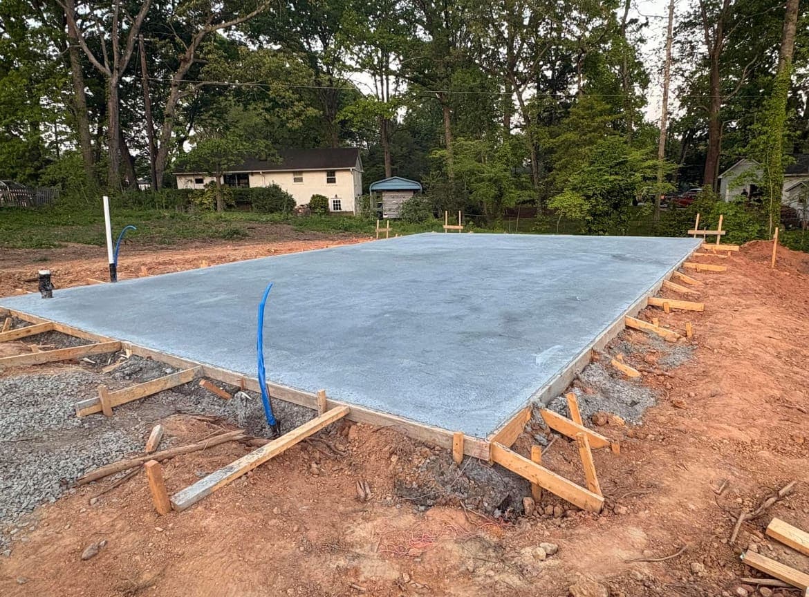 Finished Concrete Foundations job in Pineville, North Carolina by Local Concrete Contractor — clean control-joint pattern, smooth troweled surface, full property protection during pour.