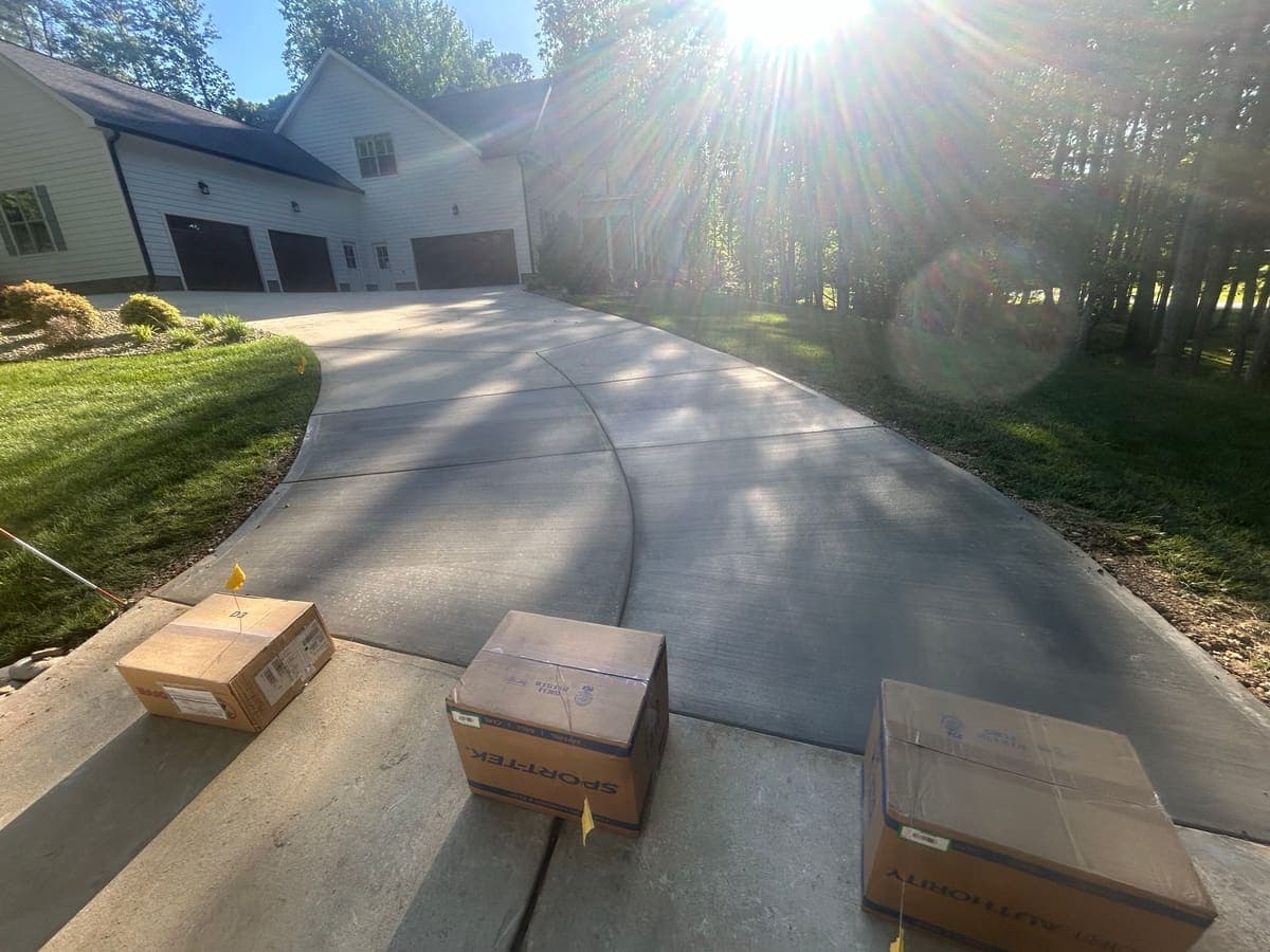 Finished Concrete Driveway Repair job in Kernersville, North Carolina by Local Concrete Contractor — clean control-joint pattern, smooth troweled surface, full property protection during pour.